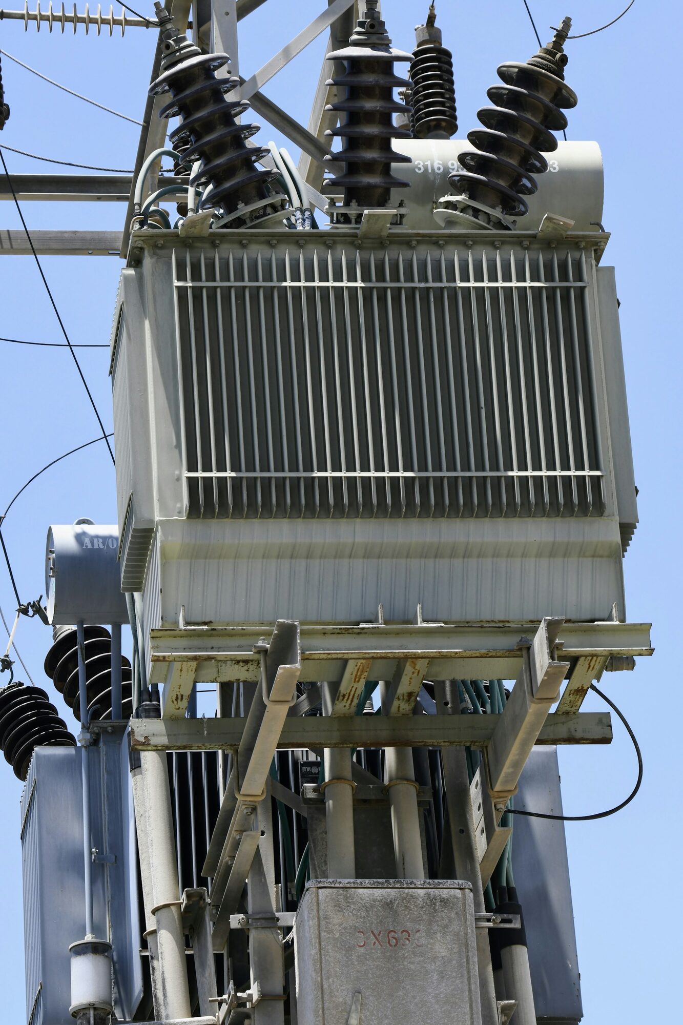 Pole mounted power transformer with high voltage bushings